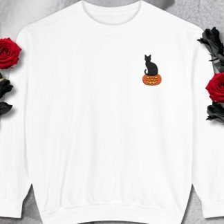 White sweatshirt with a embroidered black cat sitting on a pumpkin graphic. Red roses with black and green leaves frame the image, adding a dark, elegant touch.