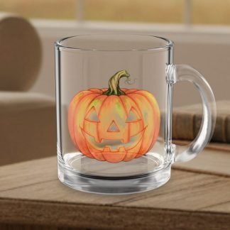 Clear glass mug with a smiling, carved pumpkin design sits on a wooden table, evoking a cozy Halloween atmosphere in a softly lit room.