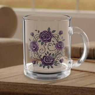 A clear glass mug with goth purple rose and vine design is placed on a wooden table indoors. The background features a cozy room with books and furniture.