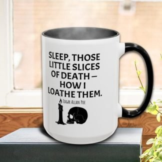 A steaming white mug with a black handle on a windowsill, featuring an Edgar Allan Poe quote about sleep and death, accompanied by a candle and skull graphic.