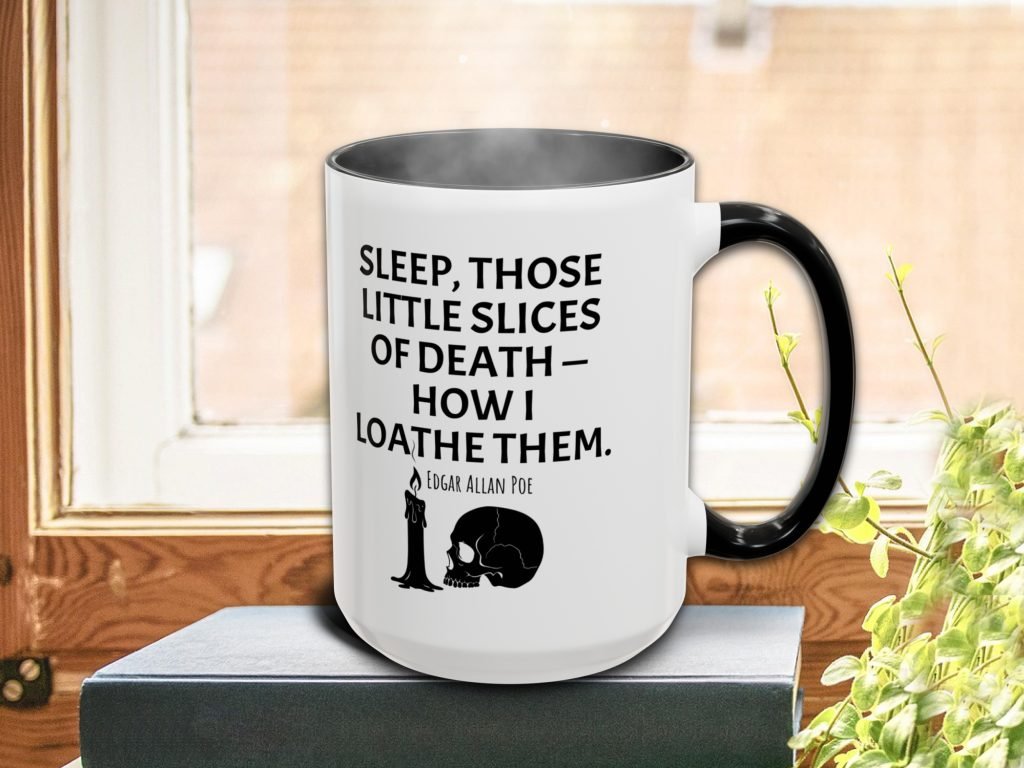 A steaming white mug with a black handle on a windowsill, featuring an Edgar Allan Poe quote about sleep and death, accompanied by a candle and skull graphic.
