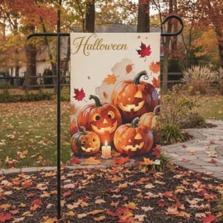 Halloween-themed garden flag depicts smiling jack-o'-lanterns surrounded by autumn leaves and a candle. The background shows fall foliage and a pathway.