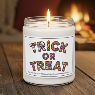 A "Trick or Treat" candle with a colorful label rests on a wooden table. The cozy, warm background shows a blurred fireplace, creating a festive, Halloween ambiance.